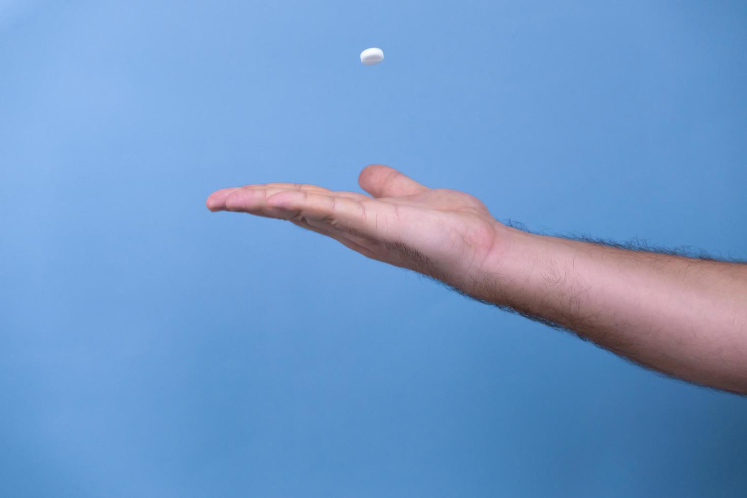 One pill in a male hand photo