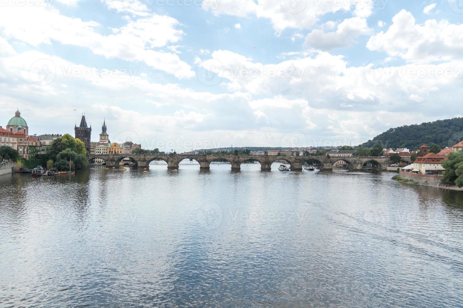Panoramic view of the Charles Bridge medieval stone arch bridge that crosses the Vltava Moldau river in Prague Czech Republic photo