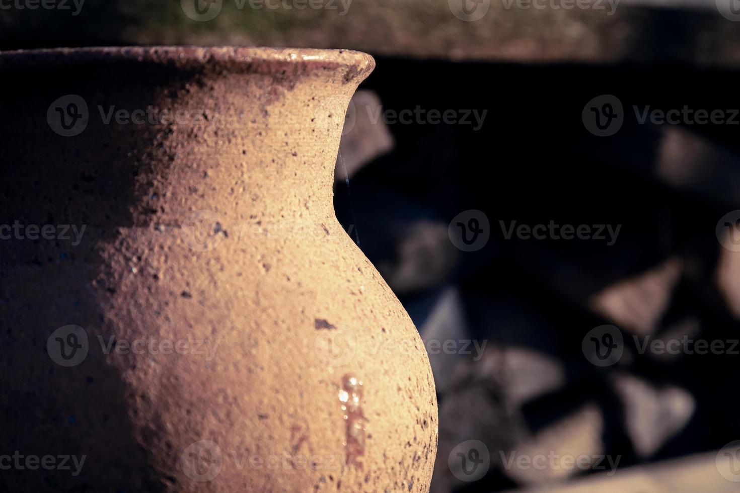 Ancient clay jug close-up outdoors on a sunny day photo