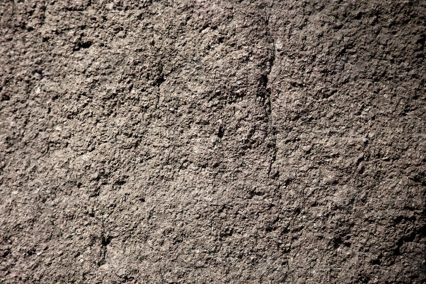 Fondo de textura de roca o piedra natural gris escabrosa foto