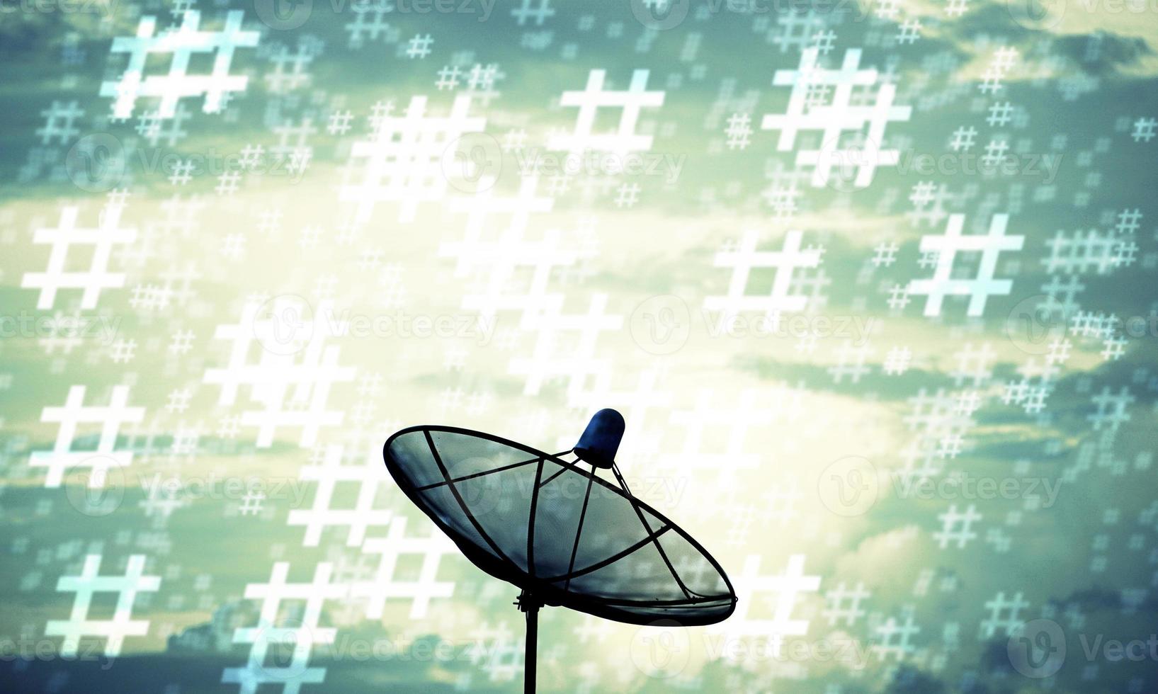 Silhouette of satellite dish and hashtag pattern photo