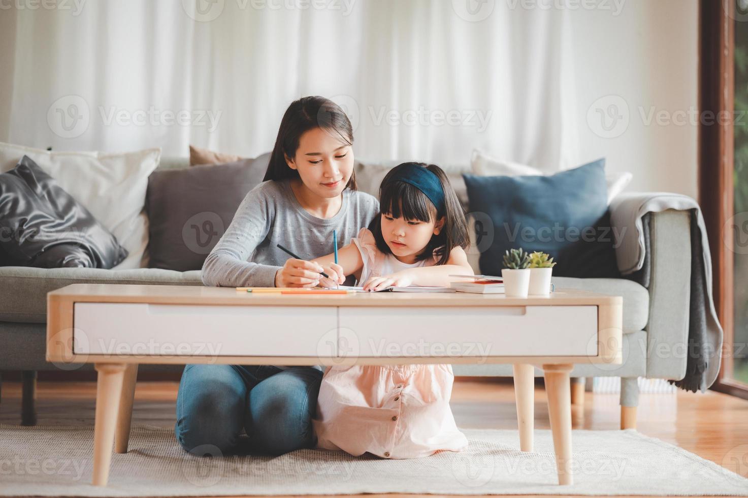 Asian mother and daughter study together photo