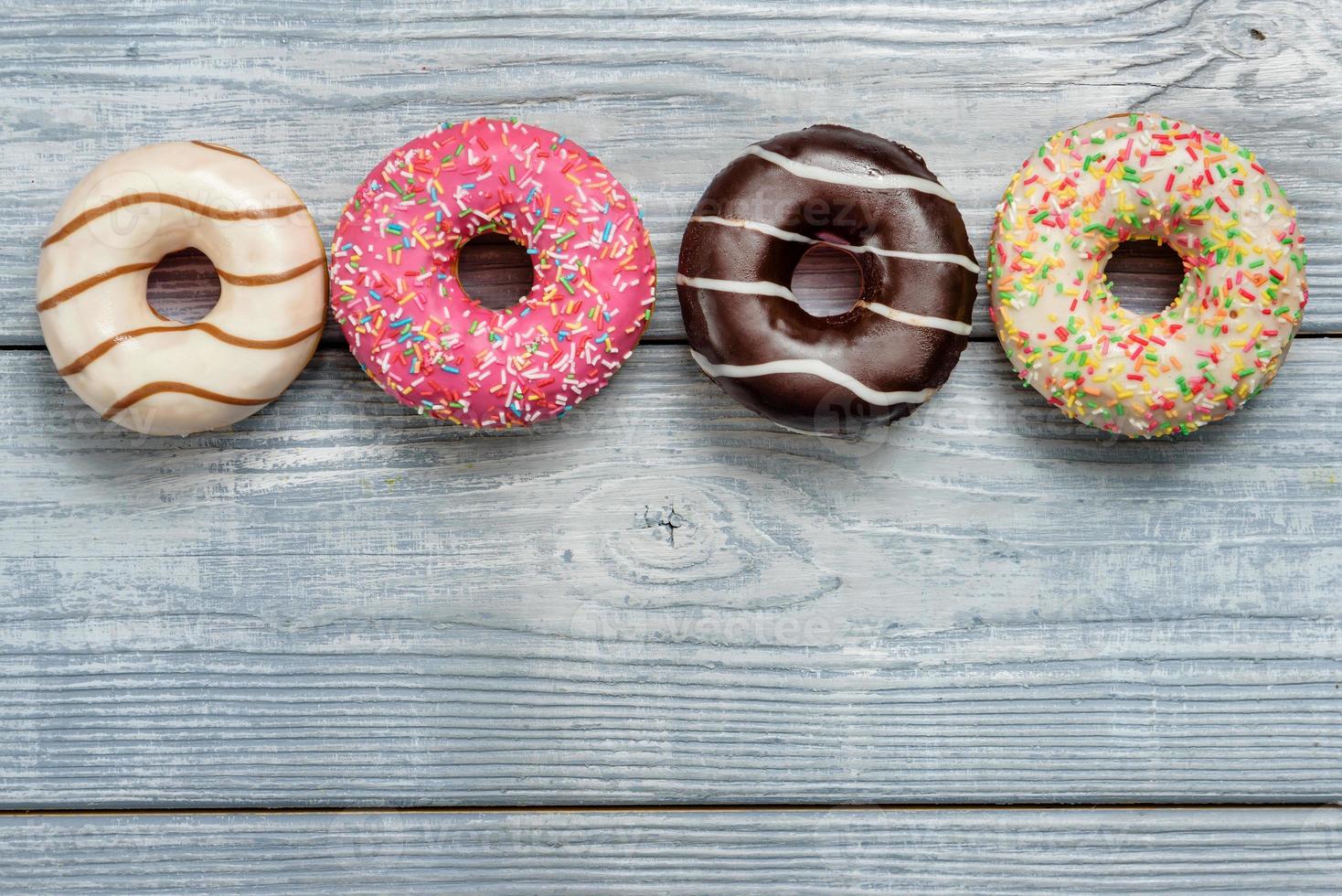 Donuts on a wooden table with copy space photo