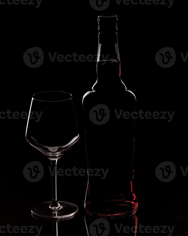 Silhouette of a bottle and a glass photo