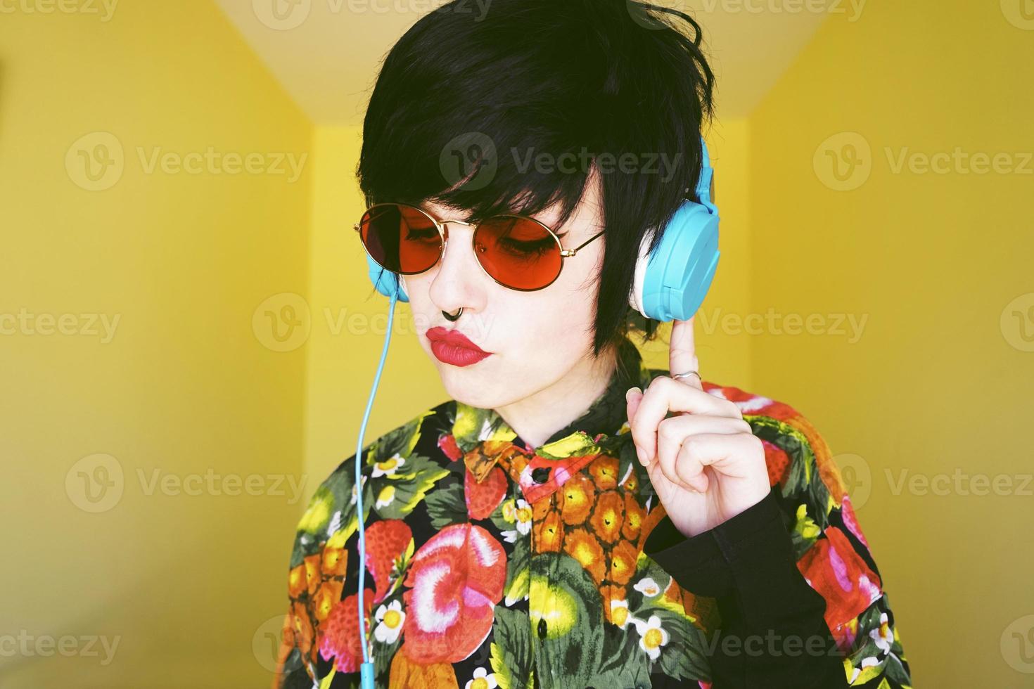 Cool androgynous dj woman in vibrant colors photo