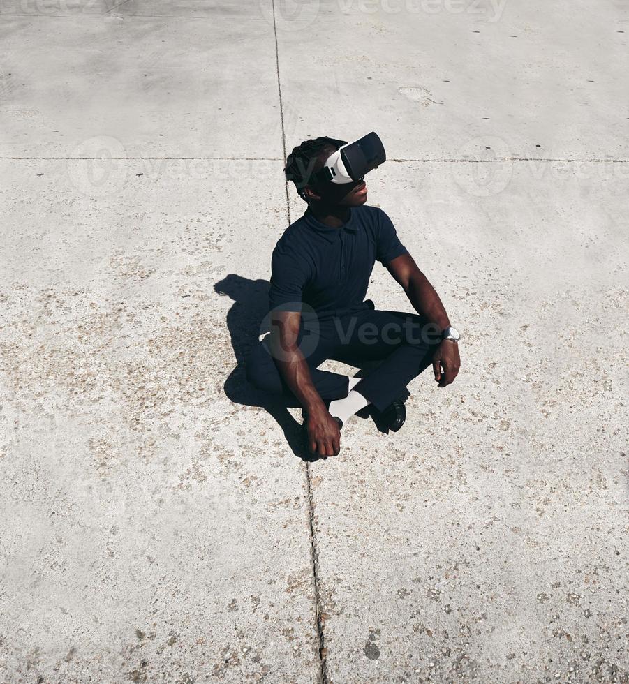 Young man wearing VR glasses photo