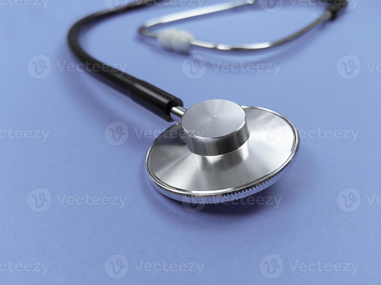 Black stethoscope on violet background Stock photo