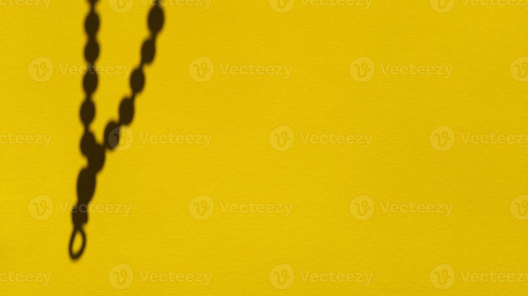 Japa beads shadows on yellow pastel paper Abstract backgorund Stock photo