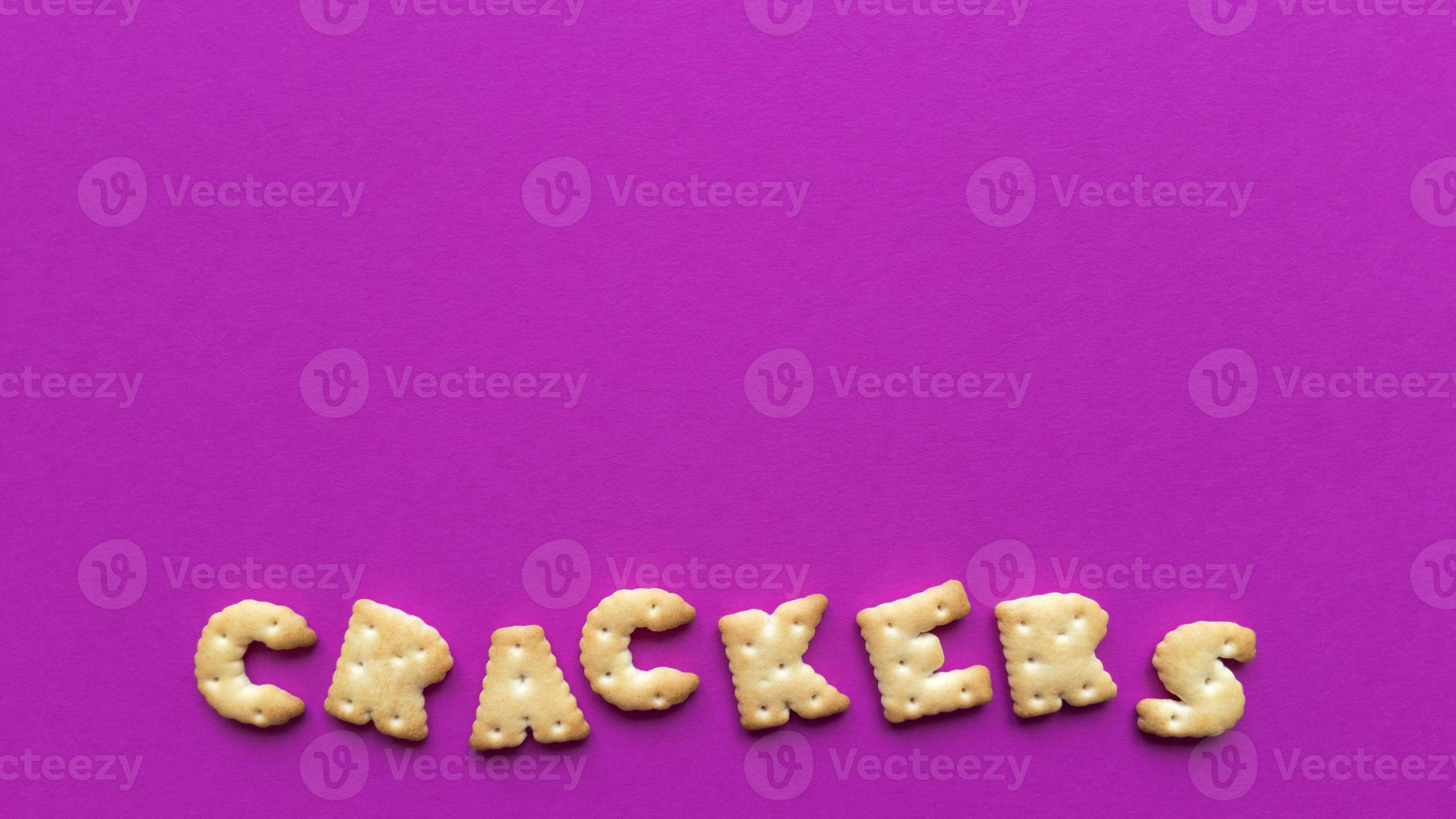 Crackers word on pink background Simple flat lay with pastel texture