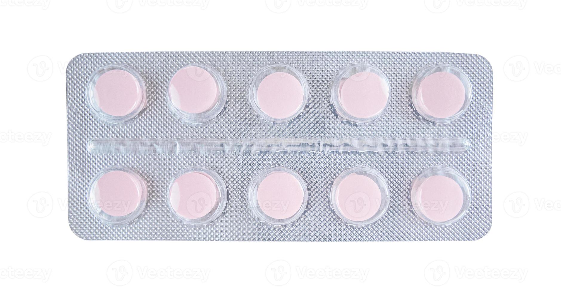 Pink tablets in blister isolated on white background photo