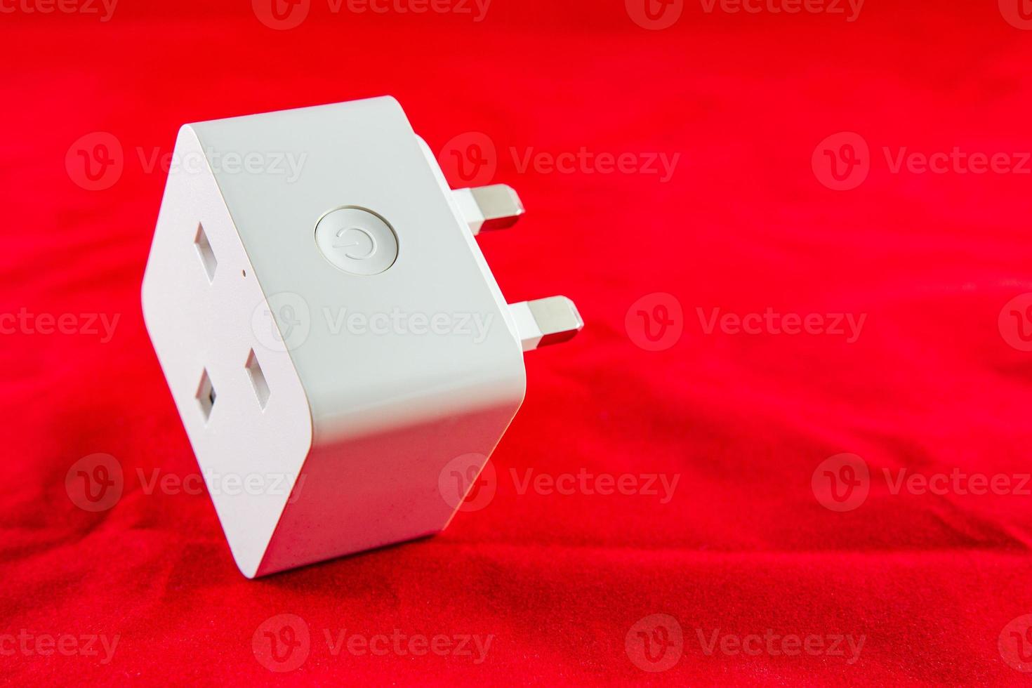 WiFi Smart Power Socket of White color on a red background photo