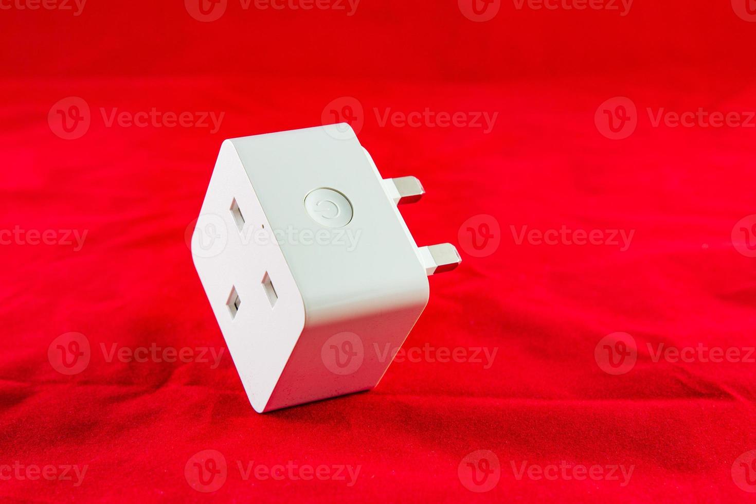 WiFi Smart Power Socket of White color on a red background photo