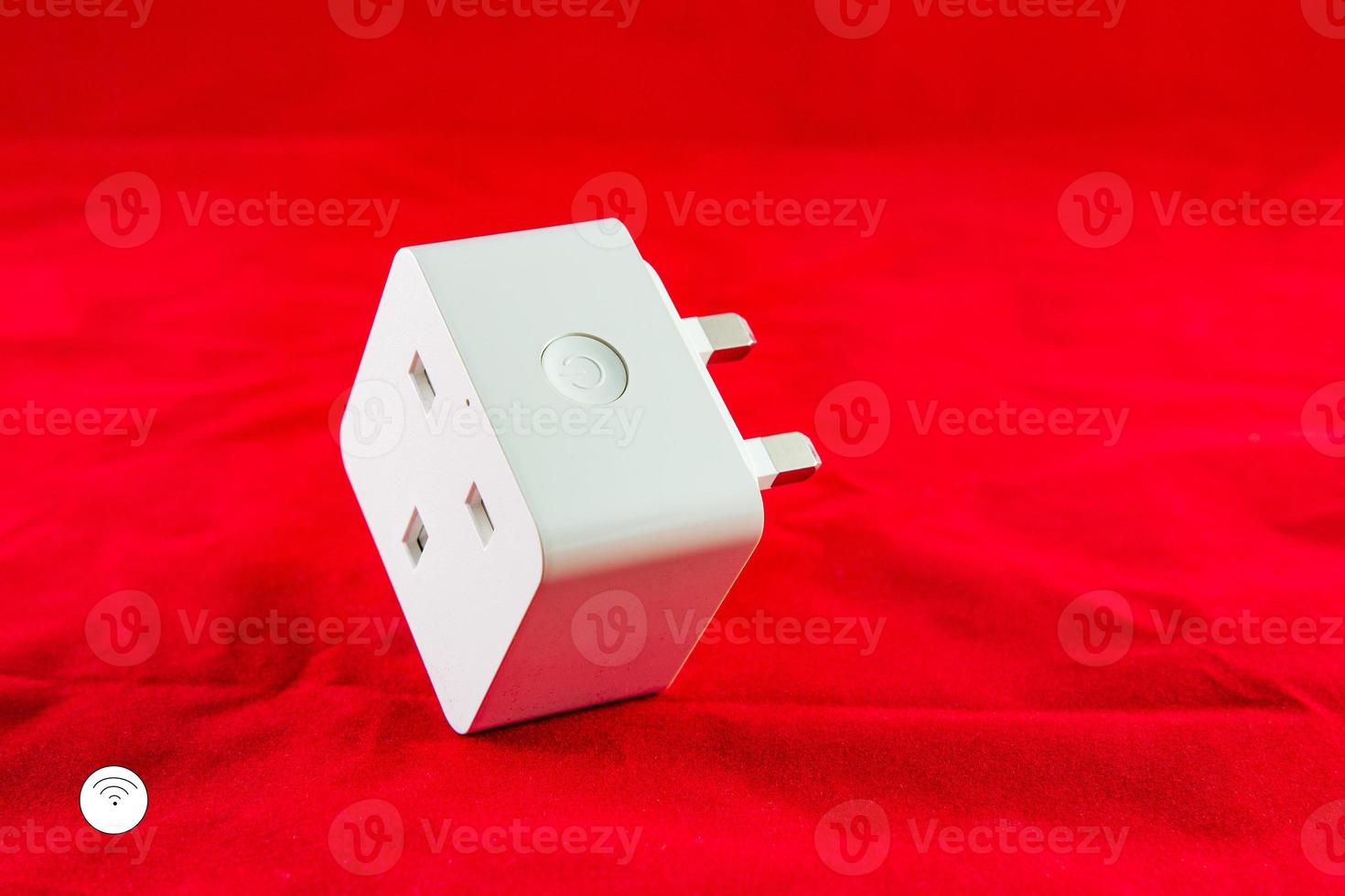 WiFi Smart Power Socket of White color on a red background photo