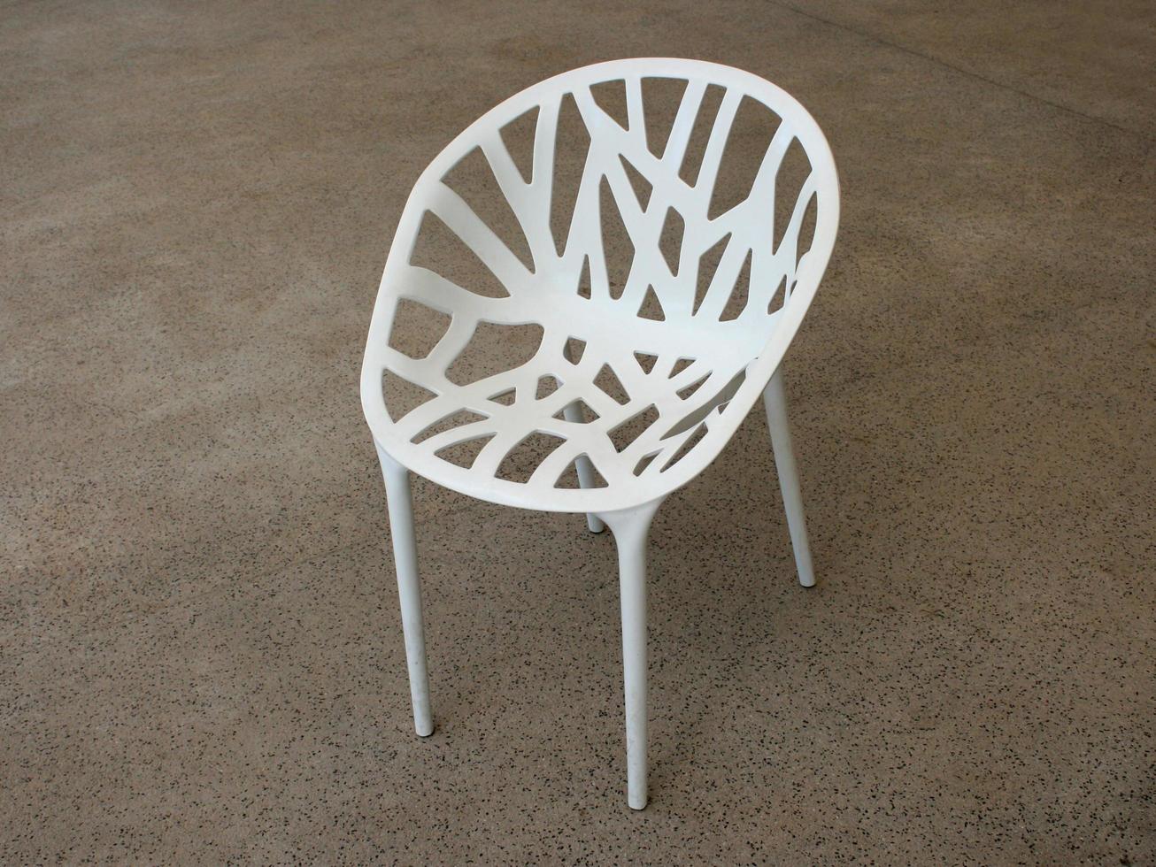 White steel chair on concrete floor photo
