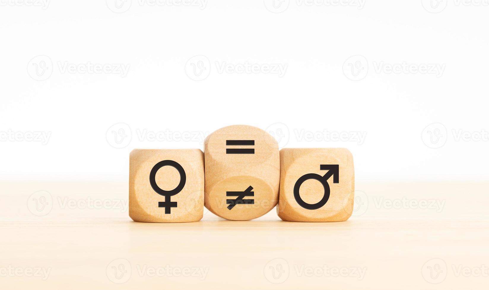 Gender equality concept Wooden block turning a unequal sign to a equal sign between symbols of men and women Copy space photo
