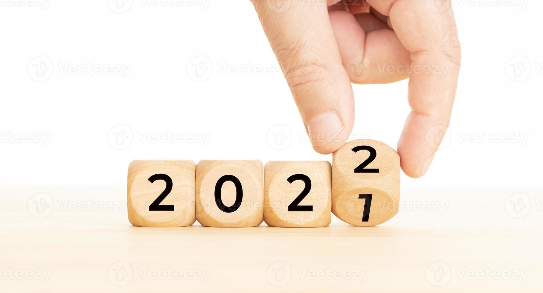 Hand changing Wooden Blocks With number 2021 to 2022 New year concept Copy space photo