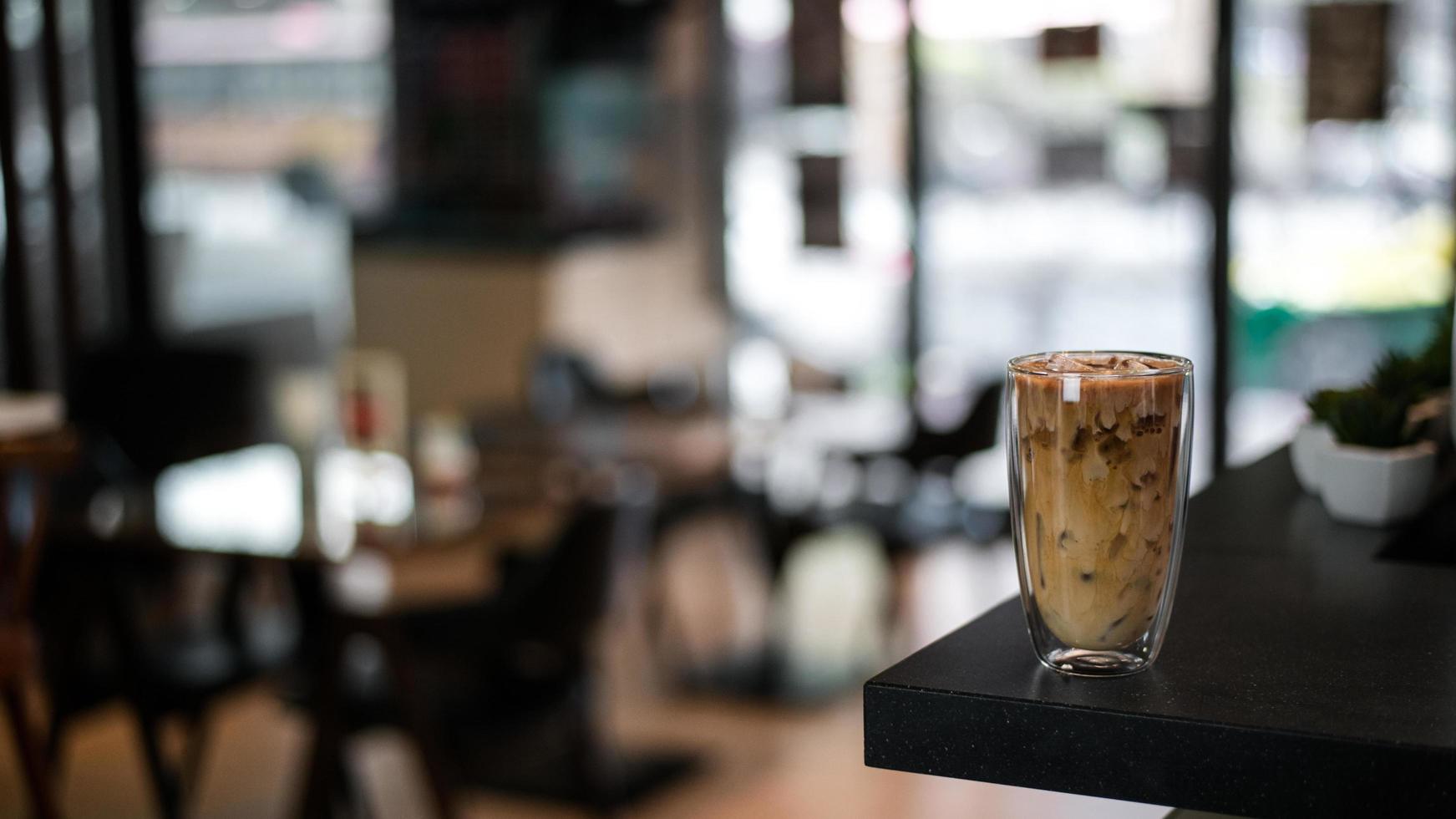 Iced coffee on a table inside a cafe photo