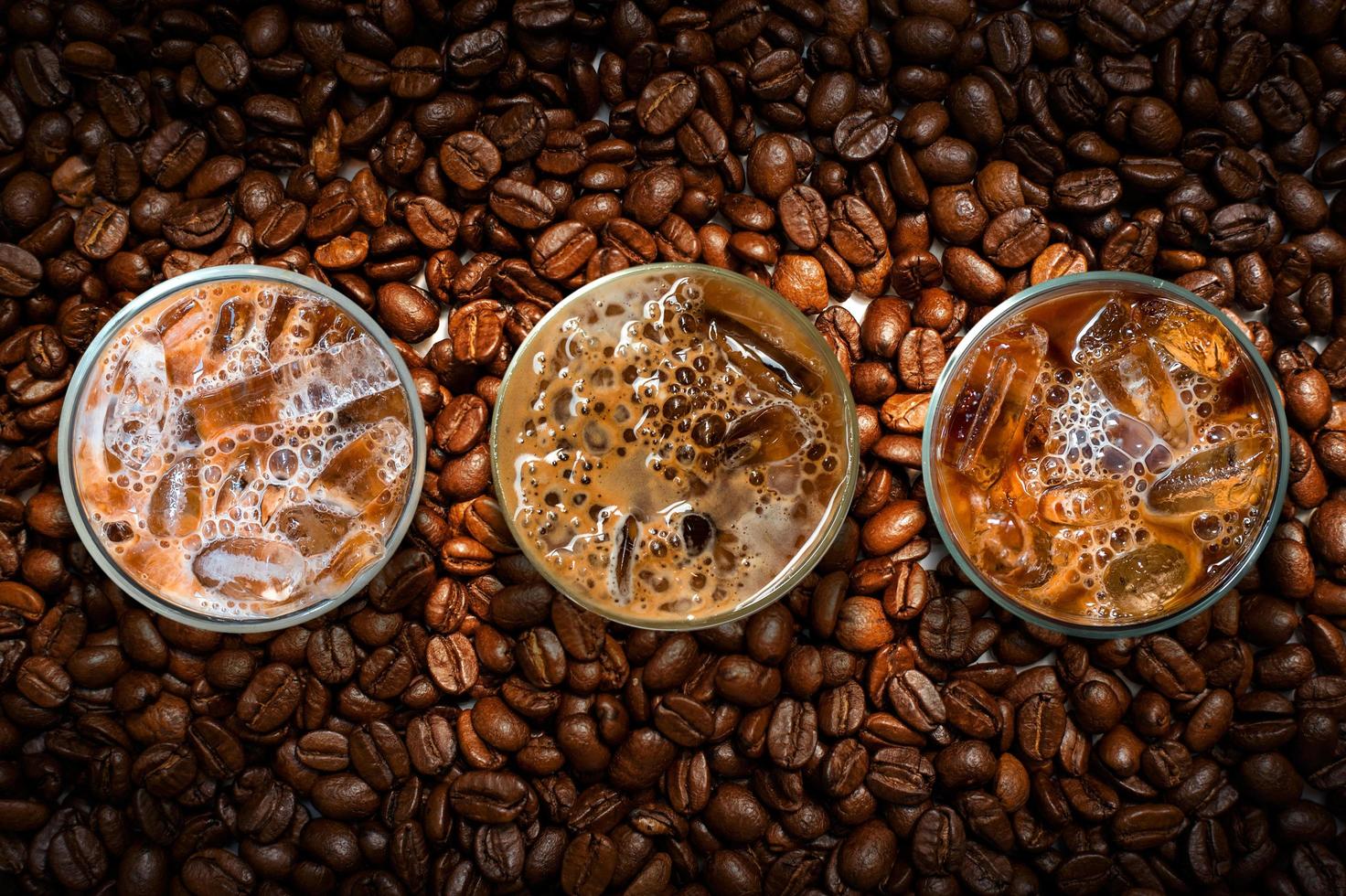 Top view of iced coffee in pile of coffee beans photo