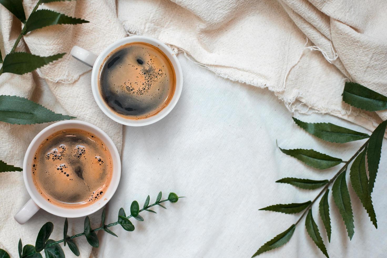 Top view of cups of coffee on a white tablecloth photo