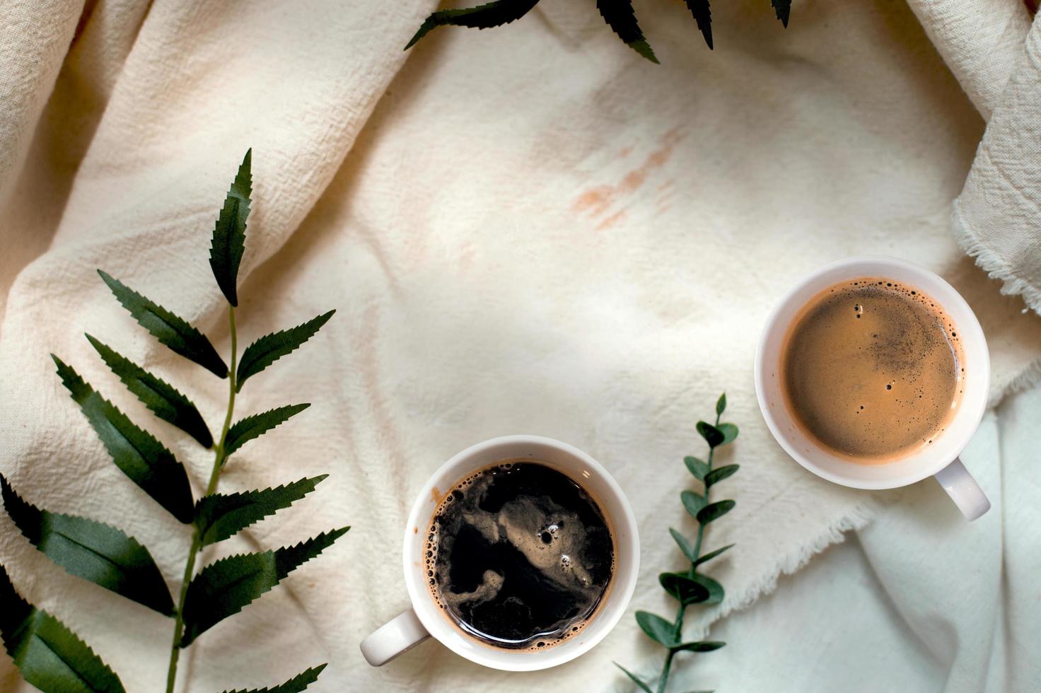 Top view of cups of coffee on a white tablecloth photo