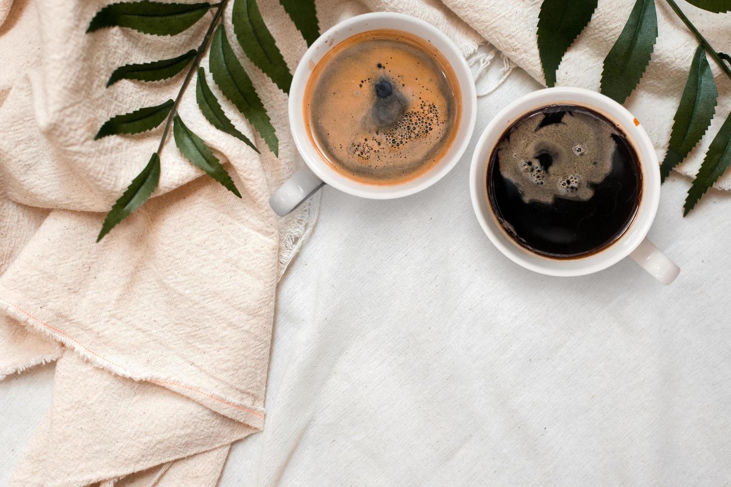 Top view of cup of coffee on a white tablecloth photo