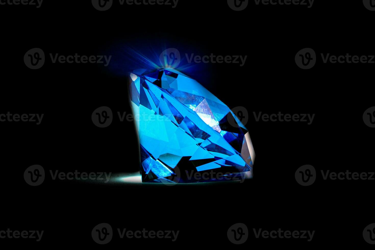 Beautiful blue diamond at isolated black background photo