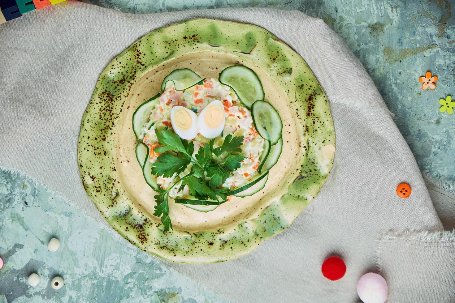 Children's salad with crab and cucumber slices photo
