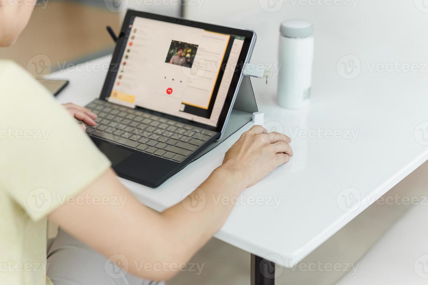 Businesswoman making video call to business partner using laptop at home photo