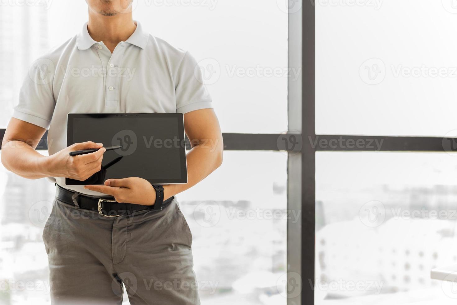 Man showing and presenting on digital tablet photo