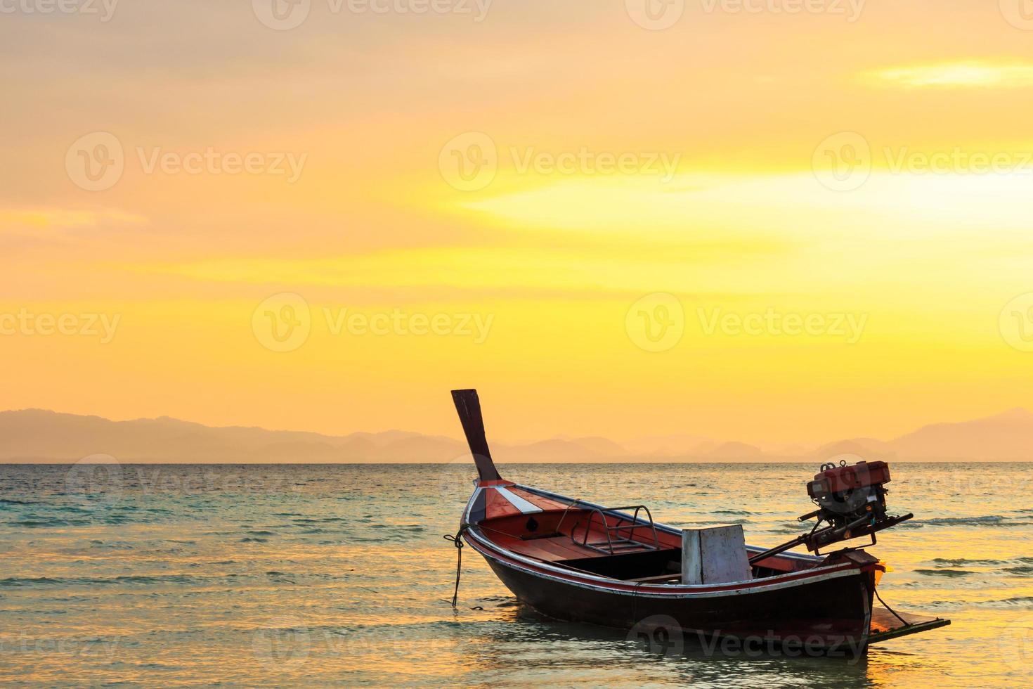 native boat on beach and sunrise in morning at Trang Thailand photo