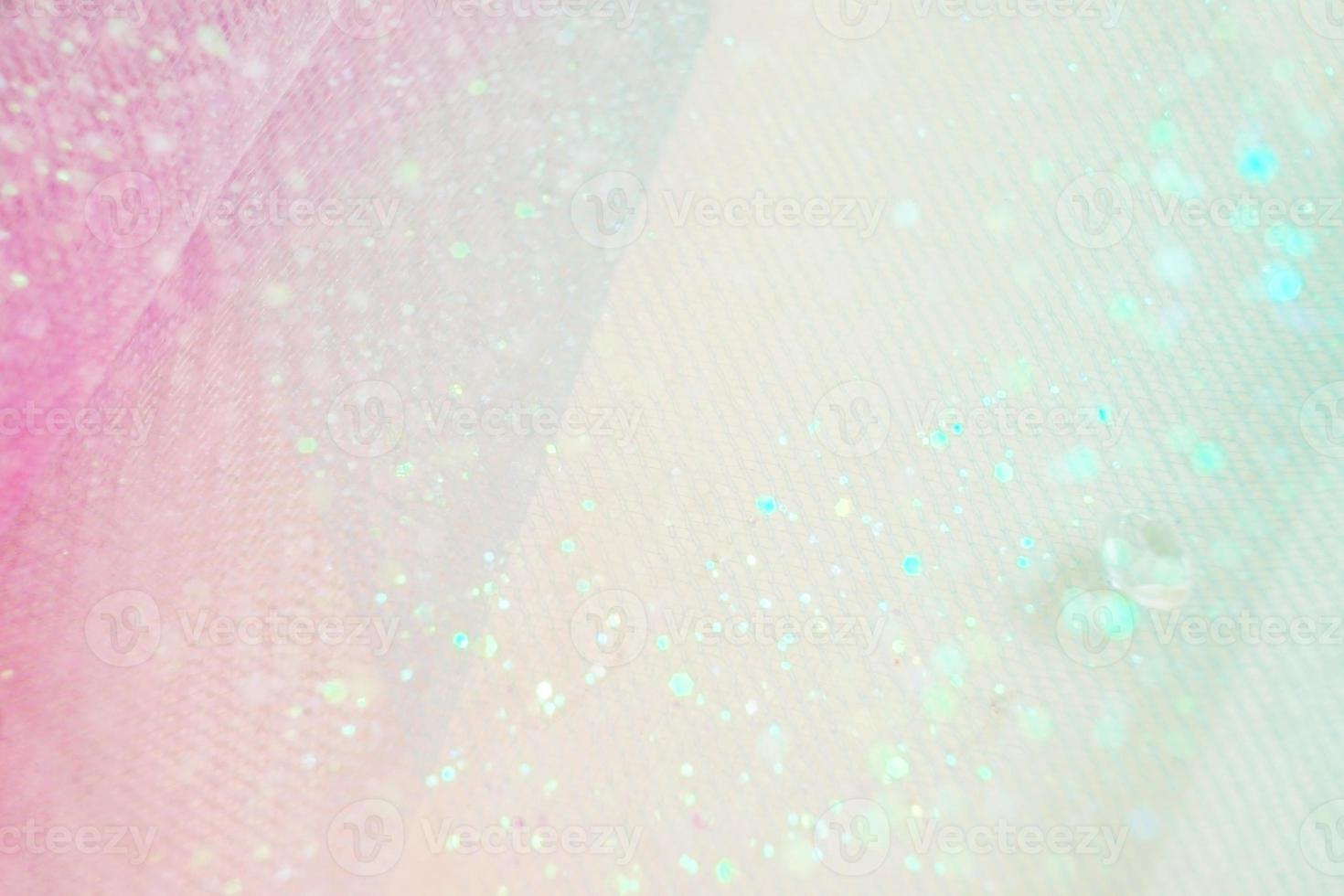 A beautiful and elegant macro of glitter from sparkling diamonds with bokeh or depth of field space and pink texture as background photo