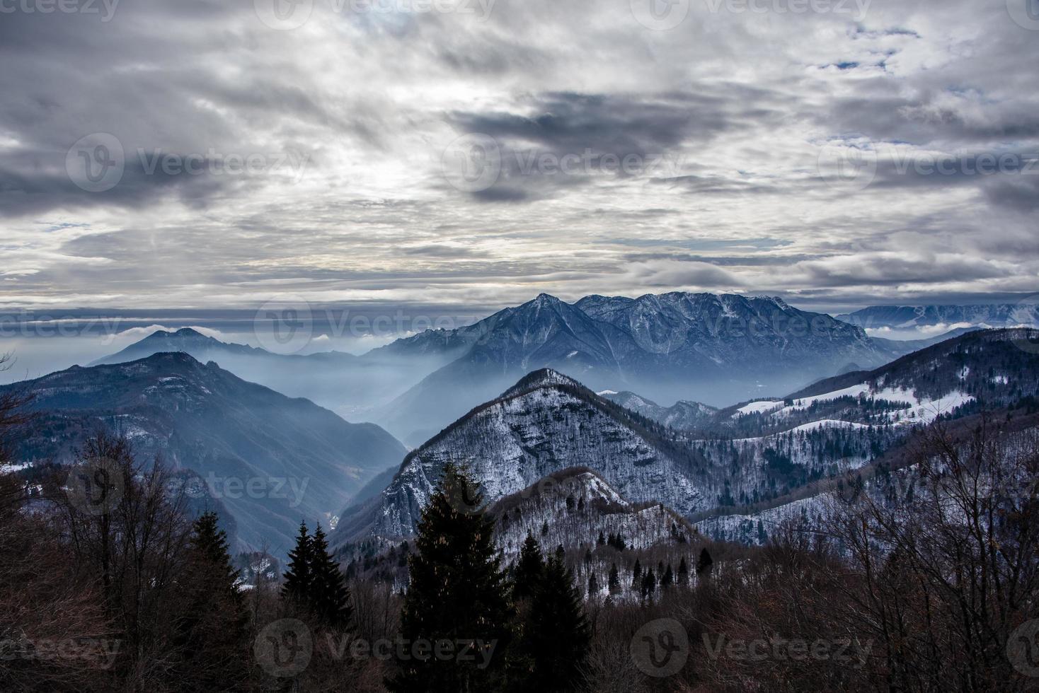 alpine valleys with snow and fog photo