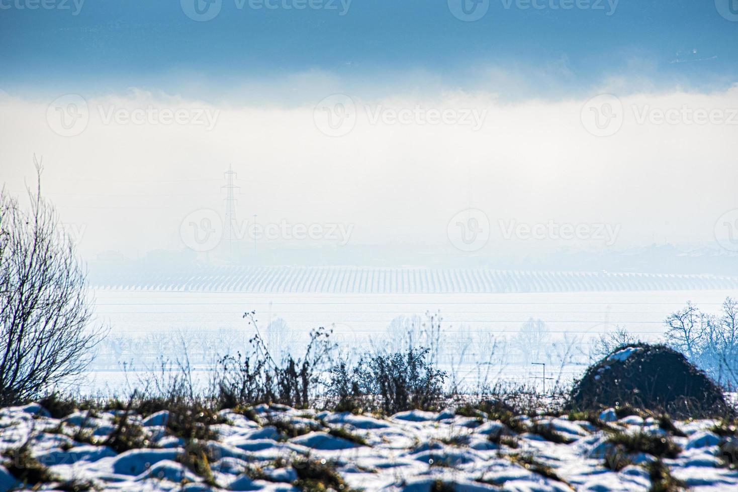 landscape between fog and snow photo