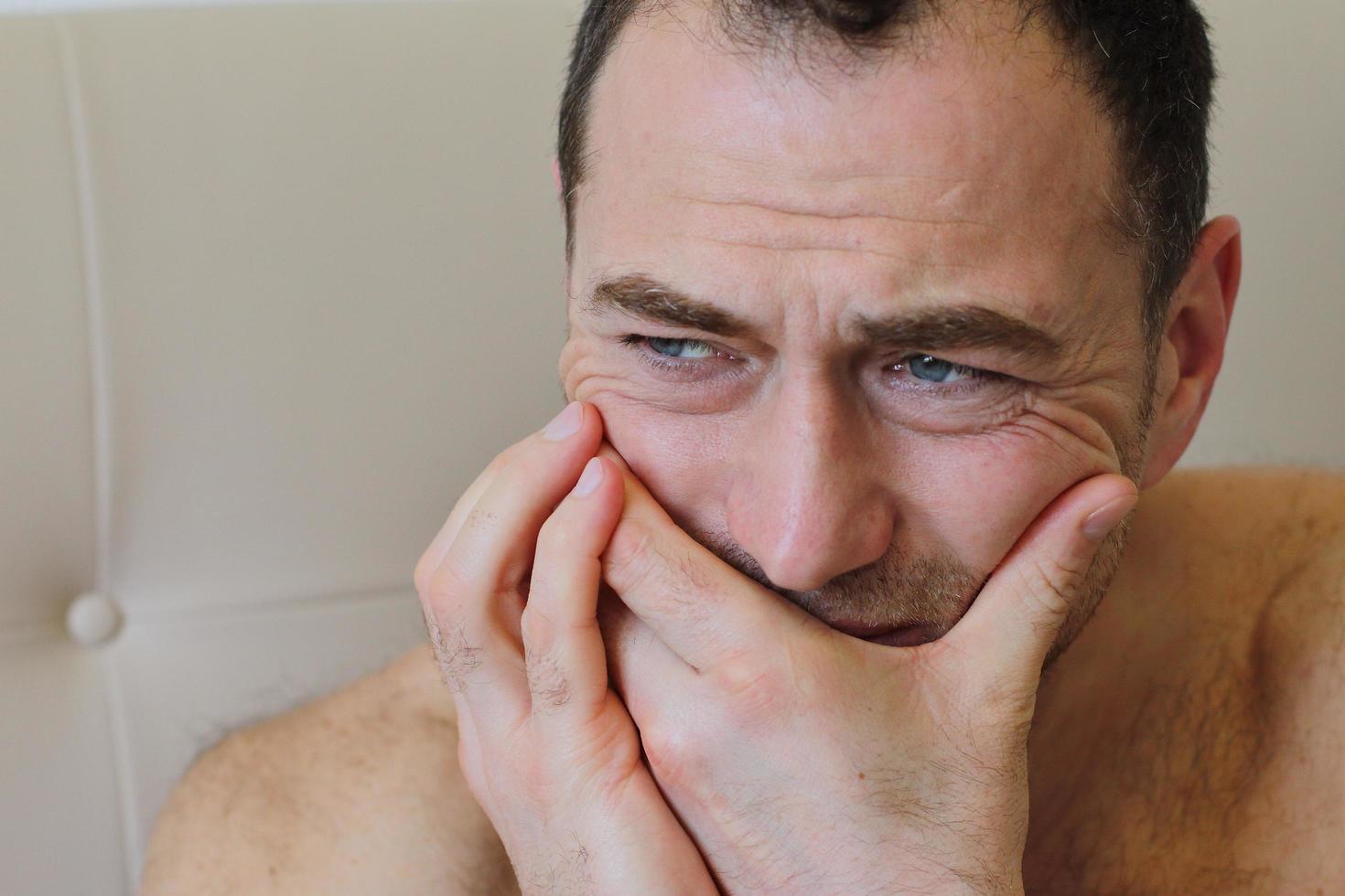 Man staying in bed with toothache photo