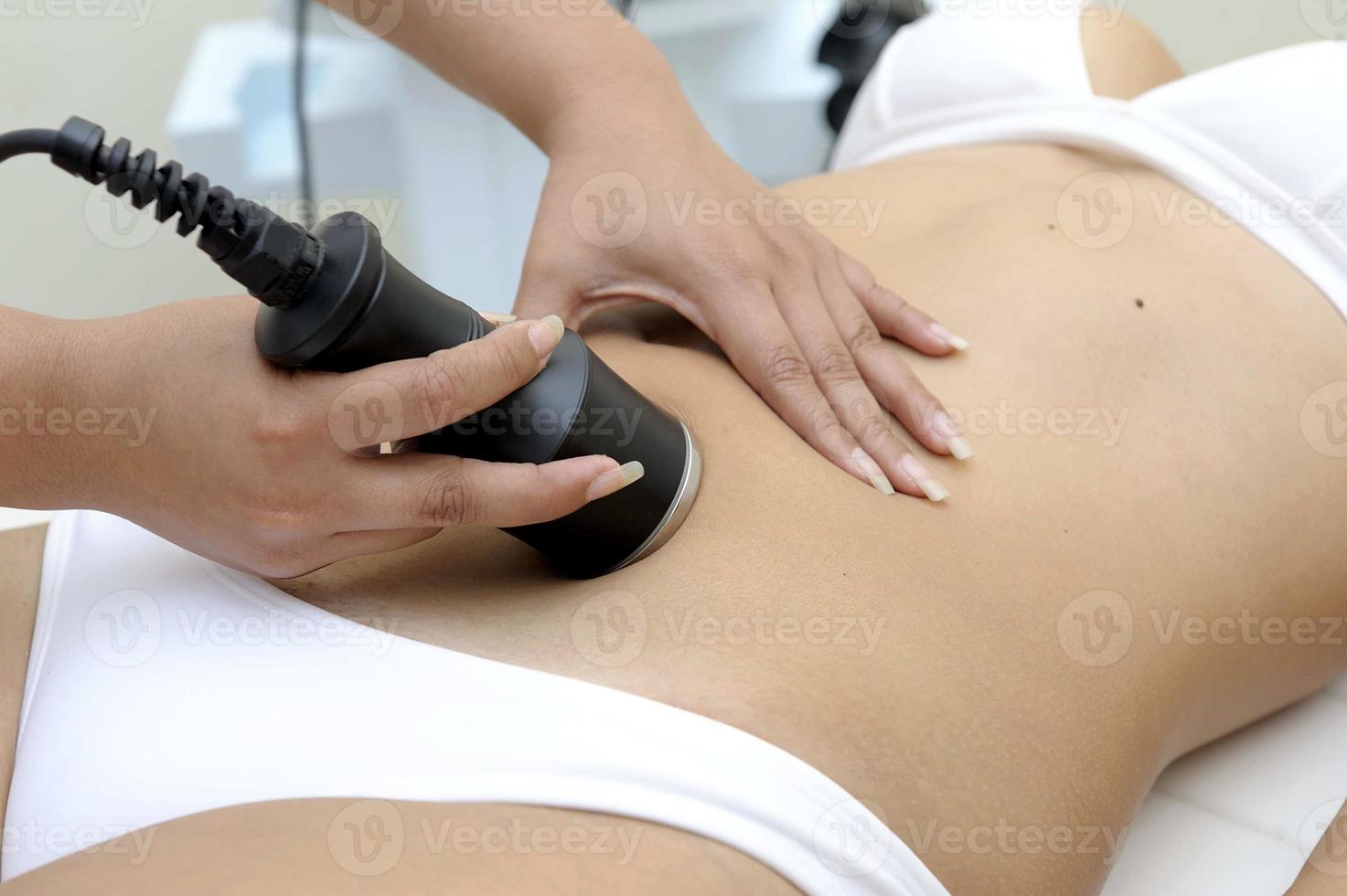 Cosmetology  Closeup Of Beautician Doing Laser Epilation Treatment On Beautiful Female Body Removing Hair On Silky Skin photo