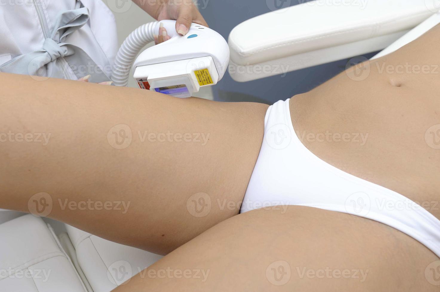 Cosmetology  Closeup Of Beautician Doing Laser Epilation Treatment On Beautiful Female Body Removing Hair On Silky Skin photo