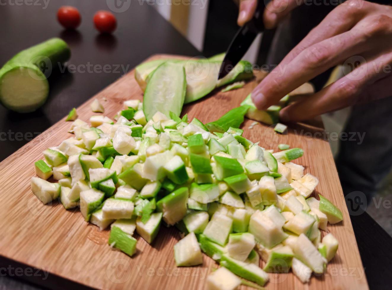 Chopped zucchini on cutting board photo