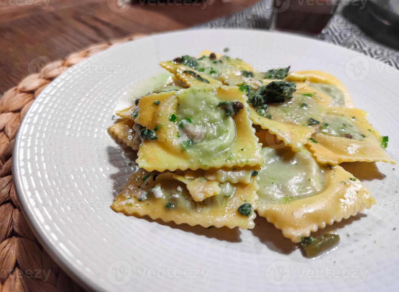 Stuffed ravioli seasoned with butter and sage photo