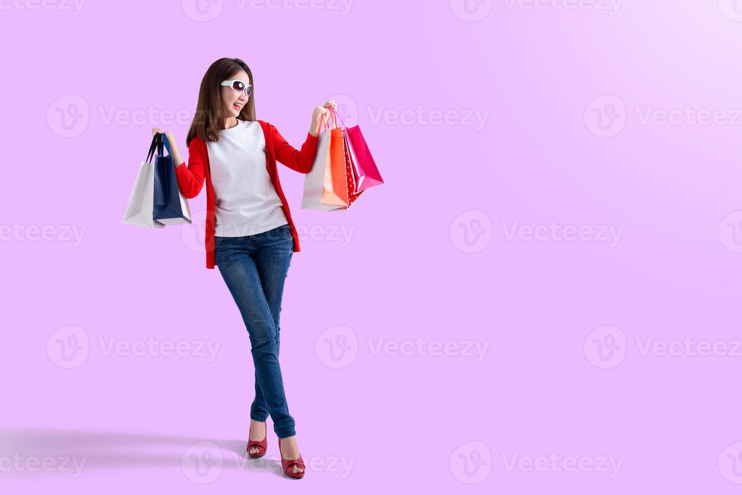 Young happy summer shopping woman with shopping bags photo