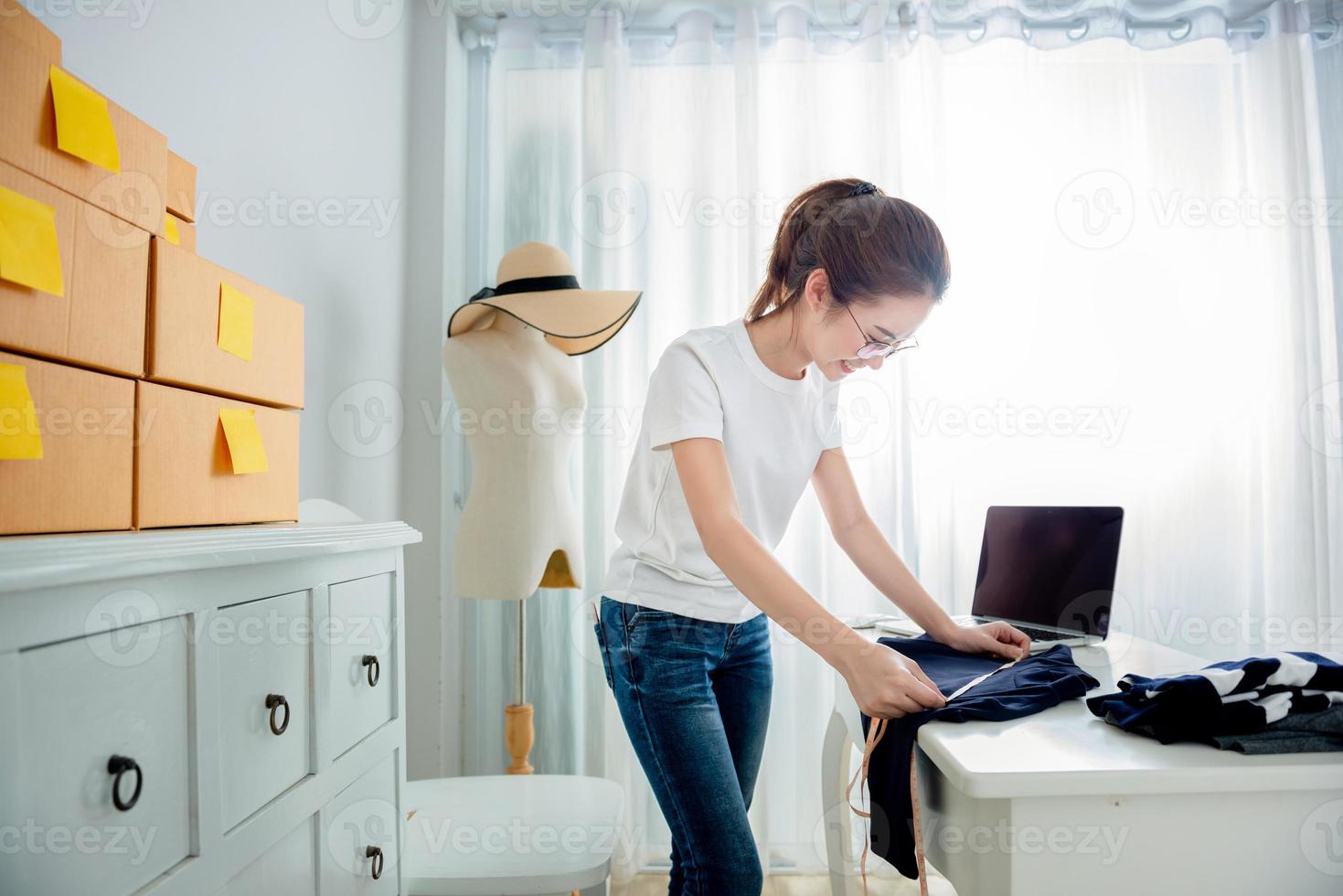 Young asian girl is freelancer with her private business at home office photo