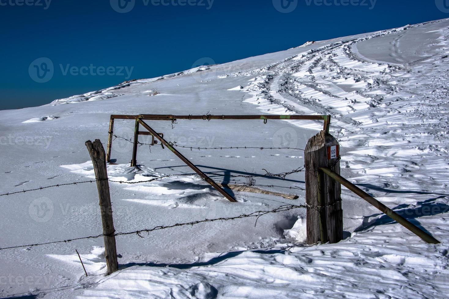 abandoned gate in the snow photo