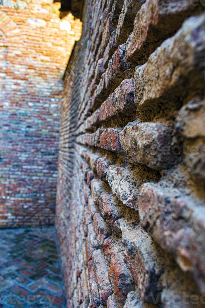 impact with ancient brick wall photo