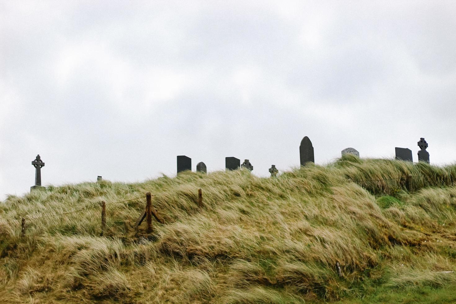 tombstones on hill photo