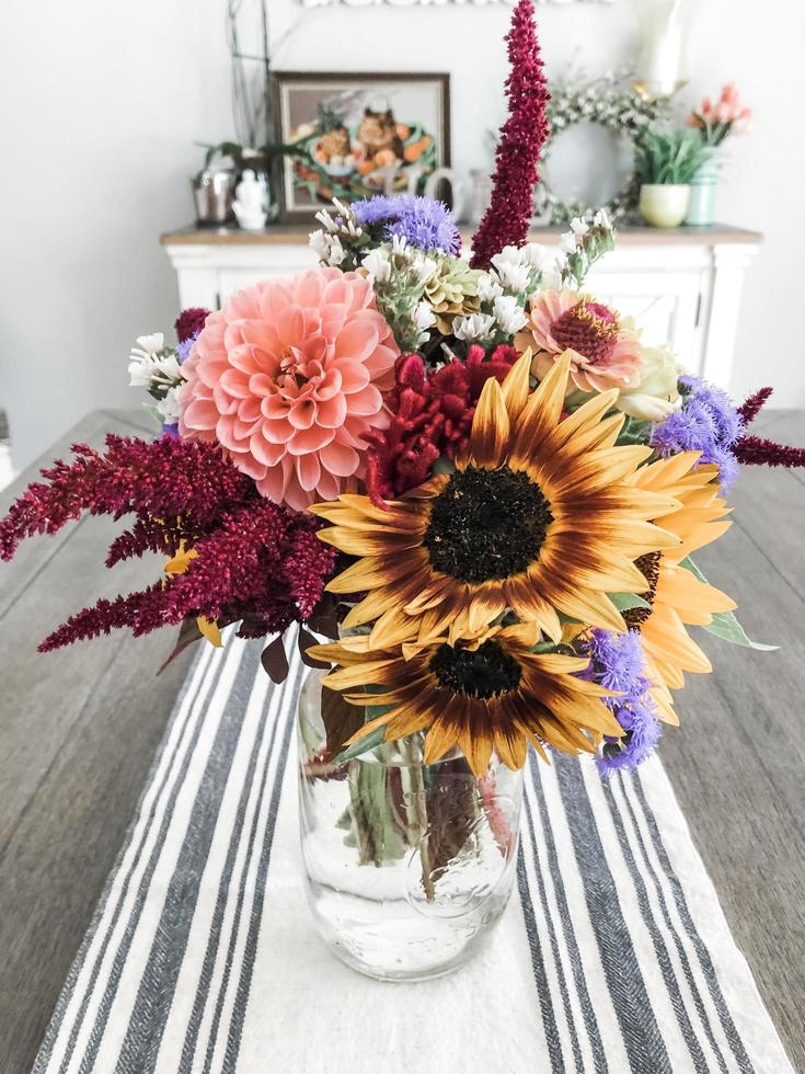 yellow and pink flowers on clear glass vase photo