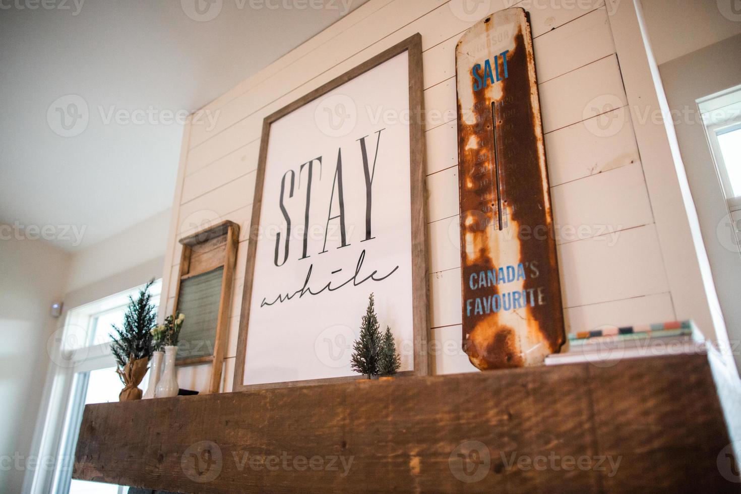 brown and white Stay awhile sign photo