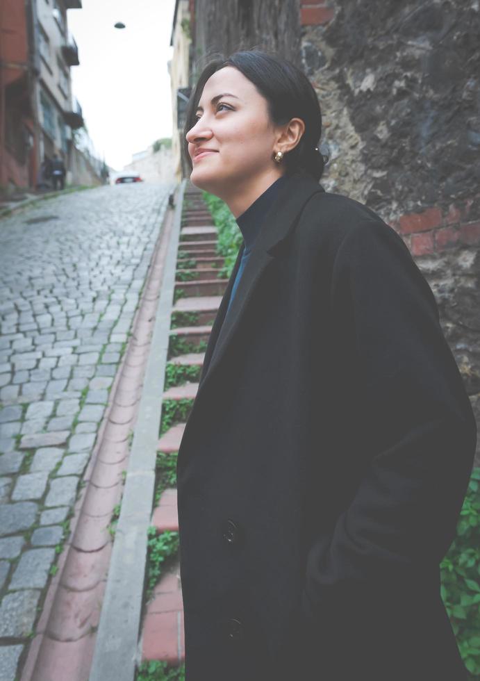 Moody, dreamy image of fashionable person smiling and looking up in beautiful surroundings in Balat, Istanbul photo