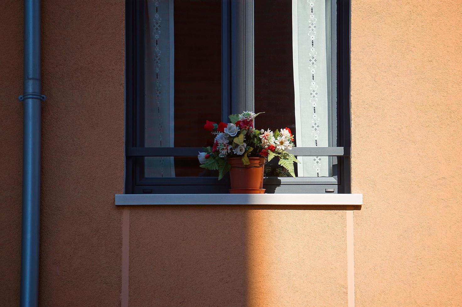 window on the orange facade of the house photo