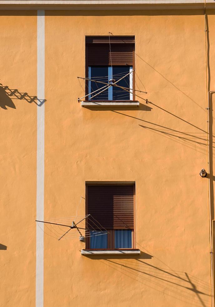 window on the orange facade of the house photo