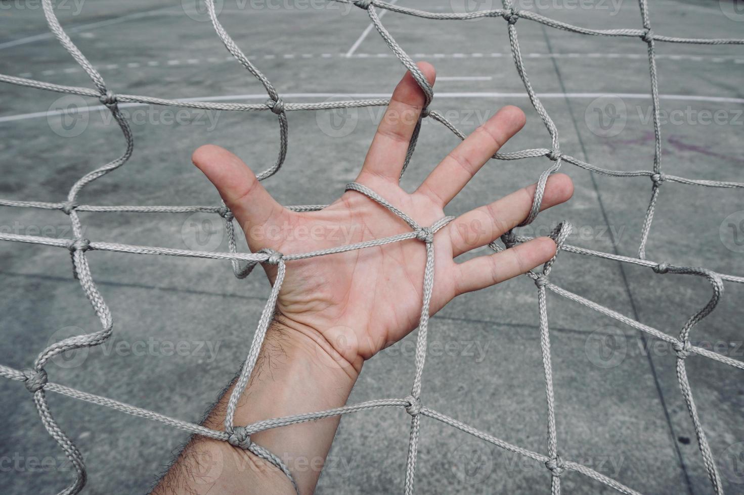 hand grabbing a rope net photo