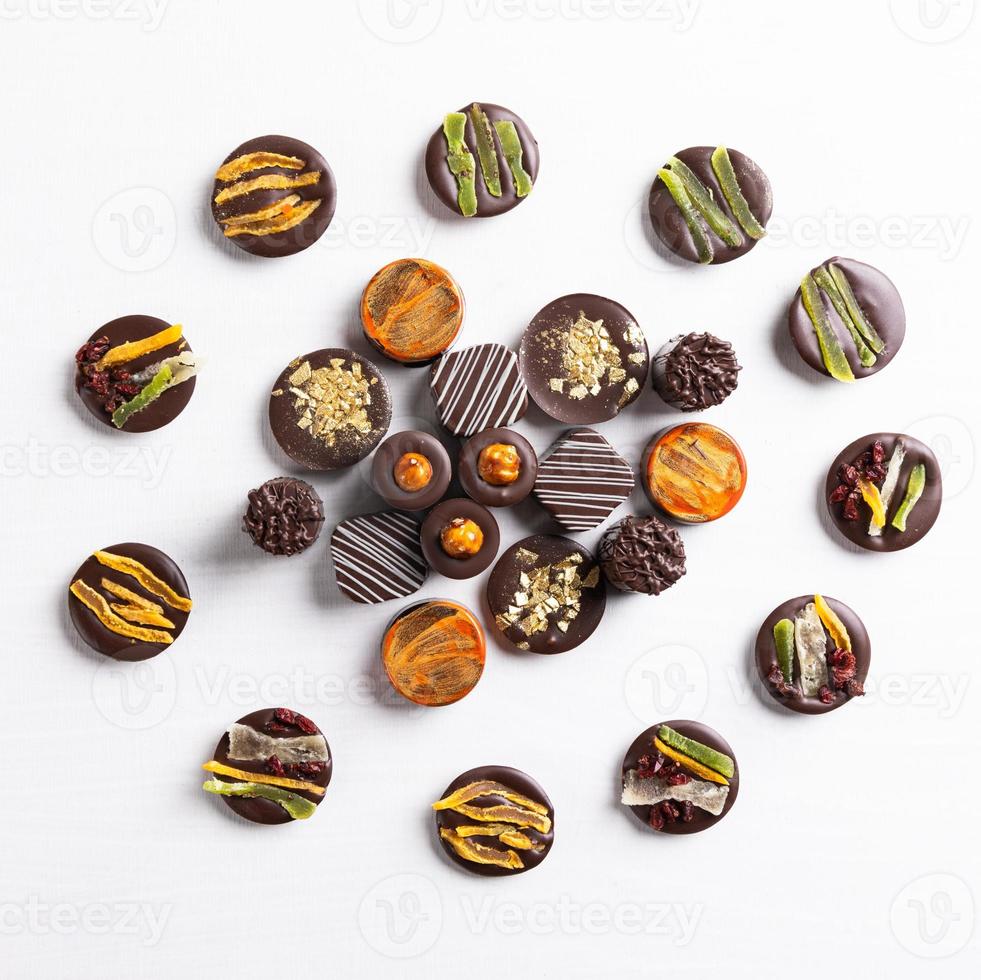 Chocolate pieces on the white background top view photo